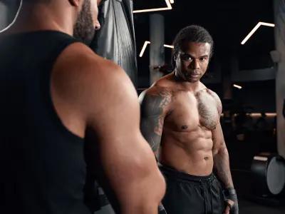 A personal trainer in Birmingham coaching a client in a modern gym, focusing on strength training.